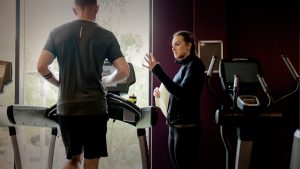 A tutor teaching a student on gym equipment on a Gym Instructor Course