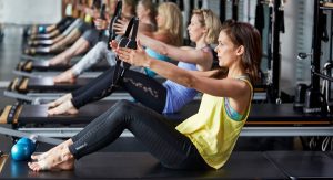 women students learning on a stott pilates mat plus course, using merrithew euipment
