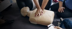 Students performing CPR on a dummy in a Emergency First Aid in the Workplace CPD course