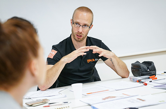 YMCAfit tutor teaching a corporate client about apprenticeships and staff training