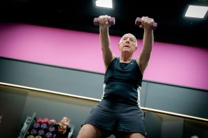 elderly gentleman exercising with weights