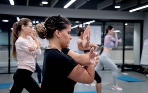 Students on the first YMCAfit women only Personal trainer course at Central YMCA Club during a practical lesson, performing a stretch