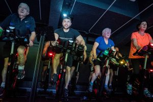 Various people on Indoor Bikes for an Indoor Cycling instructor trainer course.