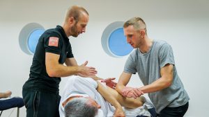 YMCA instructor teaching alignment while massaging