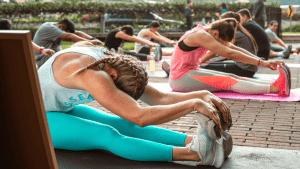 group of people stretching to aid recovery