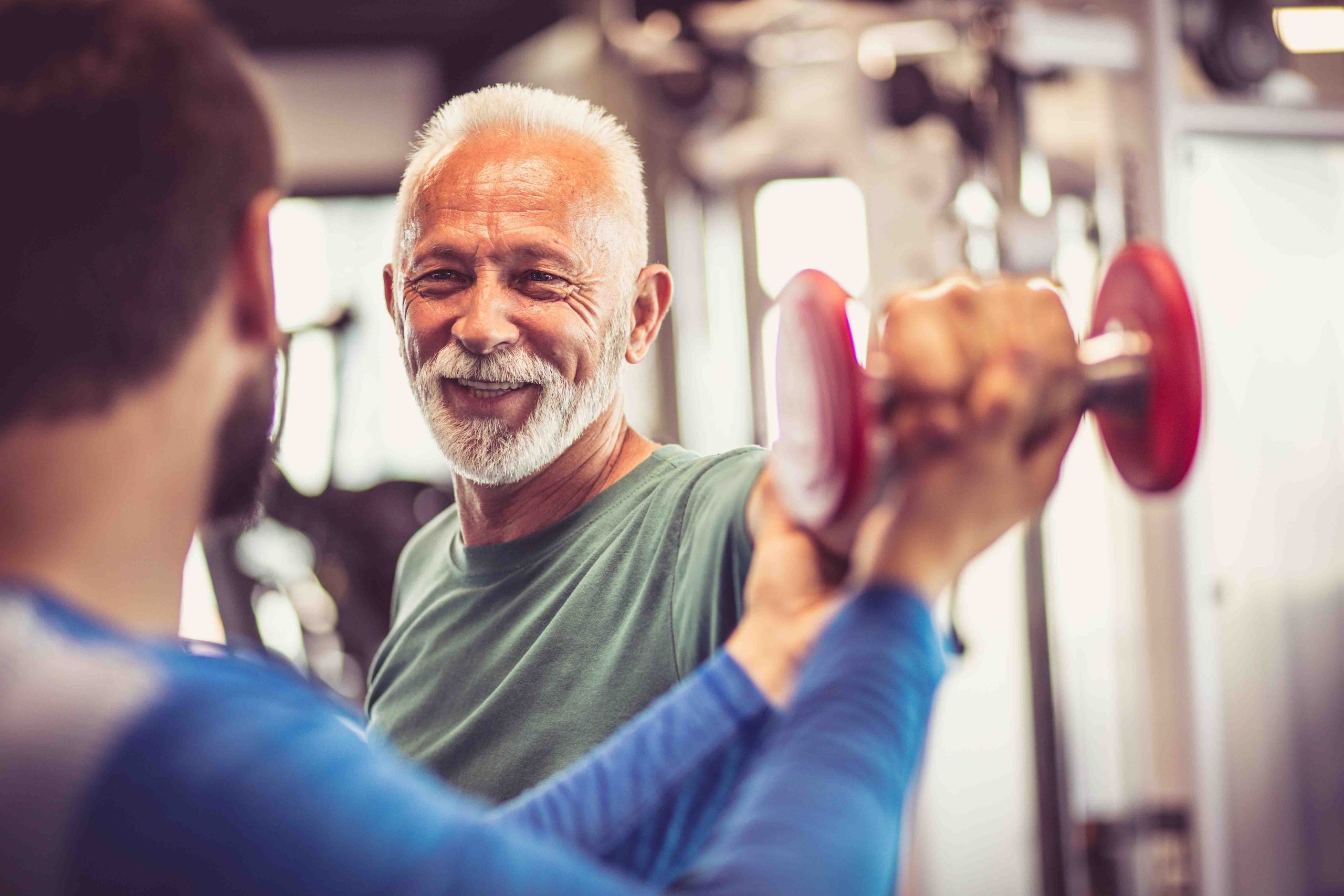 Older man smiling in gym