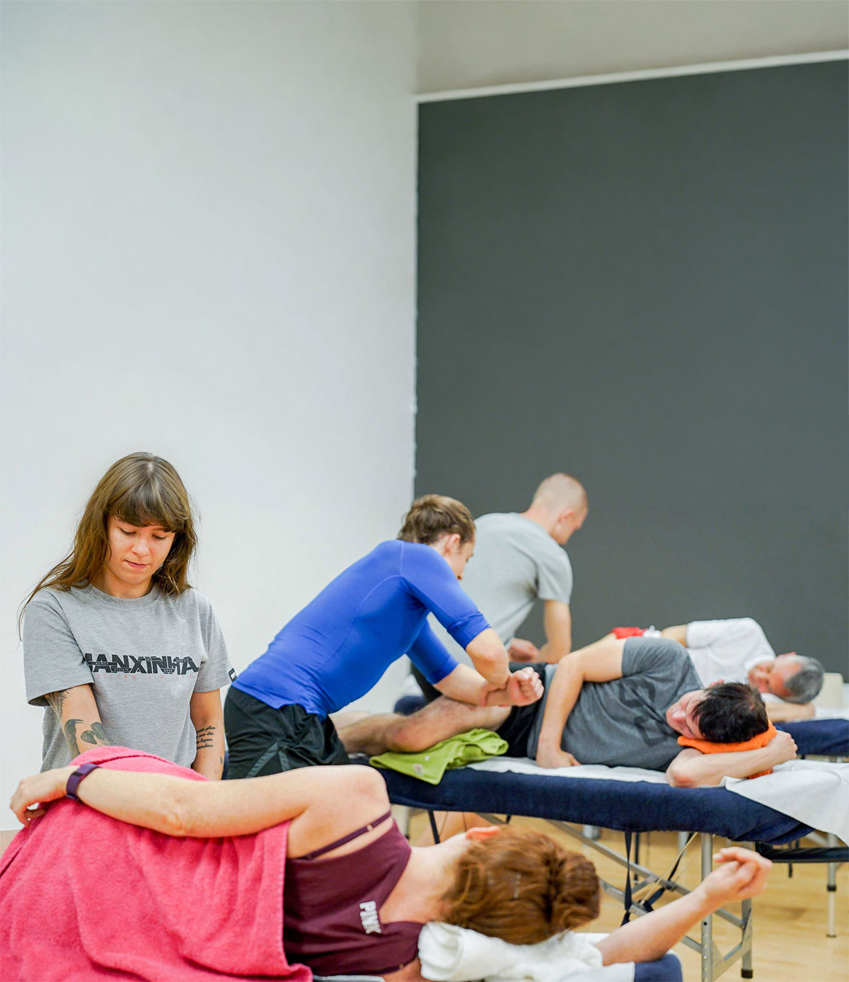 People receiving massage therapy in studio